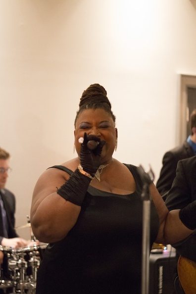 Carolyn T in black gloves and gown at a wedding reception